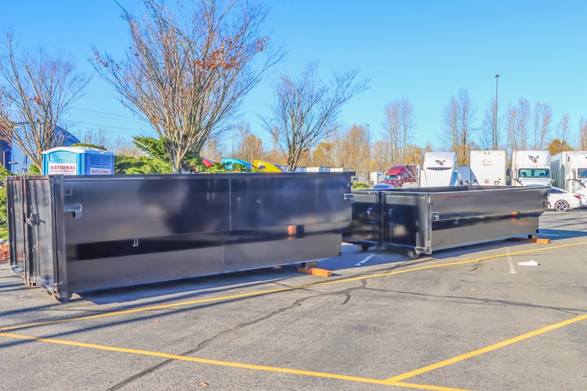 Professional dumpster rental service with roll-off container on residential driveway in Houston